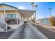 Single-wide manufactured home with carport, steps, and covered porch at 5201 W Camelback Rd # F316, Phoenix, AZ 85031