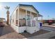 Single-wide manufactured home with carport, steps, and covered porch at 5201 W Camelback Rd # F316, Phoenix, AZ 85031