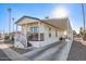 Single-wide manufactured home with carport, steps, and covered porch at 5201 W Camelback Rd # F316, Phoenix, AZ 85031