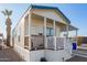 Single-wide manufactured home with carport, steps, and covered porch at 5201 W Camelback Rd # F316, Phoenix, AZ 85031