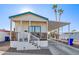 Single-wide manufactured home with carport, steps, and covered porch at 5201 W Camelback Rd # F316, Phoenix, AZ 85031