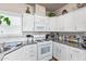 Well-equipped kitchen, white cabinets, and ample counter space at 5201 W Camelback Rd # F316, Phoenix, AZ 85031