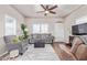 Comfortable living room featuring a sofa, armchairs, and large TV at 5201 W Camelback Rd # F316, Phoenix, AZ 85031