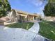 Landscaped backyard with grassy areas and a paved walkway at 741 N Tower Pl, Chandler, AZ 85225