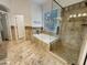 Spa-like bathroom with a soaking tub, shower, and tile floors at 741 N Tower Pl, Chandler, AZ 85225