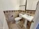 Elegant powder room with pedestal sink and tile at 741 N Tower Pl, Chandler, AZ 85225