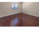 Simple bedroom with hardwood floors and a large window at 741 N Tower Pl, Chandler, AZ 85225