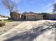 Tan house with a three-car garage and manicured lawn at 741 N Tower Pl, Chandler, AZ 85225