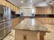 Kitchen with granite countertops, stainless steel appliances, and tile floors at 741 N Tower Pl, Chandler, AZ 85225