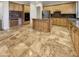 Kitchen with granite island, stainless steel appliances, and tile floors at 741 N Tower Pl, Chandler, AZ 85225