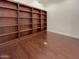 Spacious library with built-in wooden bookshelves and hardwood floors at 741 N Tower Pl, Chandler, AZ 85225