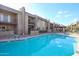 Inviting community swimming pool with surrounding patio and building views at 7436 E Chaparral Rd # B260, Scottsdale, AZ 85250