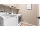 Laundry room with washer, dryer, and overhead shelving at 7517 W Noble Prairie Way, Florence, AZ 85132