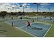 Well-lit pickleball courts with many players enjoying a game at 7517 W Noble Prairie Way, Florence, AZ 85132