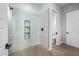 Modern tiled shower featuring built-in shelves for storage and a glass door at 8110 E Saddle Horn Rd, Scottsdale, AZ 85255