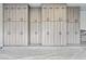 Spacious garage features custom gray cabinets with black hardware for storage and epoxy flooring at 8110 E Saddle Horn Rd, Scottsdale, AZ 85255