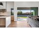 Open-concept living space with kitchen access and backyard views through large sliding glass doors at 8110 E Saddle Horn Rd, Scottsdale, AZ 85255