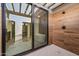 Elegant outdoor shower with wood-look tile and direct access to the luxurious bathroom and soaking tub at 8110 E Saddle Horn Rd, Scottsdale, AZ 85255