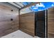 Stylish outdoor shower features wood-look tile, modern fixtures, and a relaxing open-air design at 8110 E Saddle Horn Rd, Scottsdale, AZ 85255