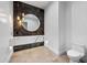 Modern powder room with a unique marble countertop, gold accents, and stylish pendant lighting at 8110 E Saddle Horn Rd, Scottsdale, AZ 85255