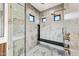 Luxurious shower featuring marble tile, bronze fixtures, and a built-in bench for added comfort at 8110 E Saddle Horn Rd, Scottsdale, AZ 85255