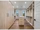 Spacious walk-in closet with custom shelving, wood floors, and ample storage for an organized wardrobe at 8110 E Saddle Horn Rd, Scottsdale, AZ 85255