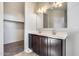 Double vanity bathroom with a large mirror and adjacent closet at 8506 S 256Th Dr, Buckeye, AZ 85326