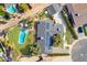 Stunning aerial view of a home with a large backyard, sparkling pool, green lawn, and solar panels on the roof at 8521 N 15Th Dr, Phoenix, AZ 85021