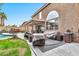 Outdoor patio area with covered seating, grill station, and adjacent pool at 9230 E Fairfield St, Mesa, AZ 85207