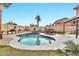 Inviting backyard oasis with kidney-shaped pool, patio, and lush landscaping at 9230 E Fairfield St, Mesa, AZ 85207