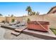 Relax in the backyard hot tub, surrounded by desert landscaping at 9230 E Fairfield St, Mesa, AZ 85207