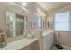 Bathroom features a double vanity and large mirror at 10027 W Concord Ave, Sun City, AZ 85351