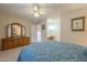 Spacious bedroom with dresser and view into bathroom at 10027 W Concord Ave, Sun City, AZ 85351