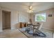 Bright dining area with table and chairs near a window at 10027 W Concord Ave, Sun City, AZ 85351