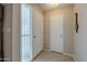 Simple entryway with tiled floor, coat closet, and a patterned glass door at 10027 W Concord Ave, Sun City, AZ 85351