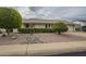 Single-story home with landscaped front yard, driveway, and neutral color scheme at 10027 W Concord Ave, Sun City, AZ 85351