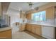 Kitchen features light wood cabinets, a double sink, and a dishwasher at 10027 W Concord Ave, Sun City, AZ 85351