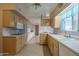 Kitchen with light wood cabinets, built in microwave and oven at 10027 W Concord Ave, Sun City, AZ 85351