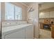 Laundry room with washer, dryer, and built-in cabinets at 10027 W Concord Ave, Sun City, AZ 85351