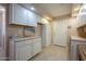 Laundry room with ample storage and counter space at 10027 W Concord Ave, Sun City, AZ 85351