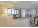 Living room showcasing a ceiling fan, built-in shelving, and large window at 10027 W Concord Ave, Sun City, AZ 85351