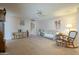 Living room with a view into kitchen, comfortable seating and a ceiling fan at 10027 W Concord Ave, Sun City, AZ 85351