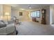 Living room featuring a ceiling fan, hardwood floors, and ample natural light at 10027 W Concord Ave, Sun City, AZ 85351