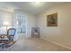 Bright living room with rocking chair and view into kitchen at 10027 W Concord Ave, Sun City, AZ 85351