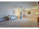 Spacious living room with neutral carpeting, ceiling fan, and comfortable seating at 10027 W Concord Ave, Sun City, AZ 85351