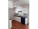 Updated kitchen with white shaker cabinets, dark countertops, and tile backsplash at 10030 W Royal Oak Rd # C, Sun City, AZ 85351