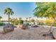 Landscaped area with large rocks and lake view at 10030 W Royal Oak Rd # C, Sun City, AZ 85351