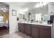 Double vanity bathroom with modern dark brown cabinets and a large mirror at 10447 W Appaloosa Trl, Casa Grande, AZ 85194