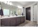 Modern bathroom with double vanity, large mirror, and walk-in shower at 10447 W Appaloosa Trl, Casa Grande, AZ 85194