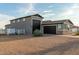 Two-story house with a large garage and a horse in the background at 10447 W Appaloosa Trl, Casa Grande, AZ 85194